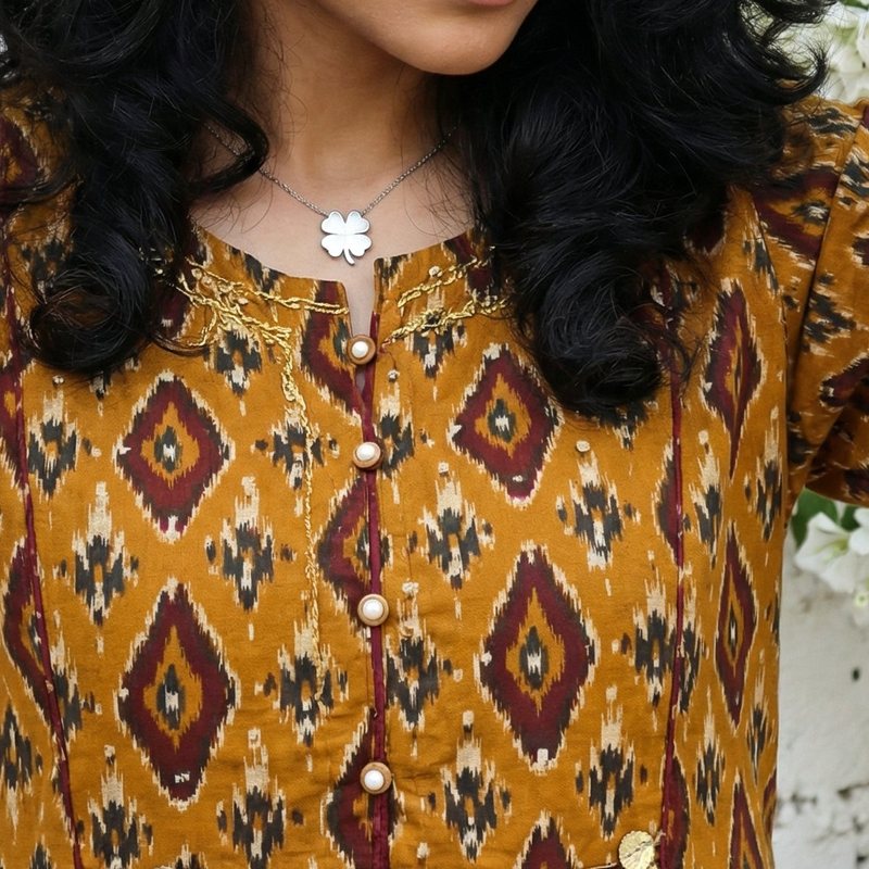 Close-up of the neckline with pearl-look buttons and gold sequin work, Sequence & Coin Fusion mustard kurta