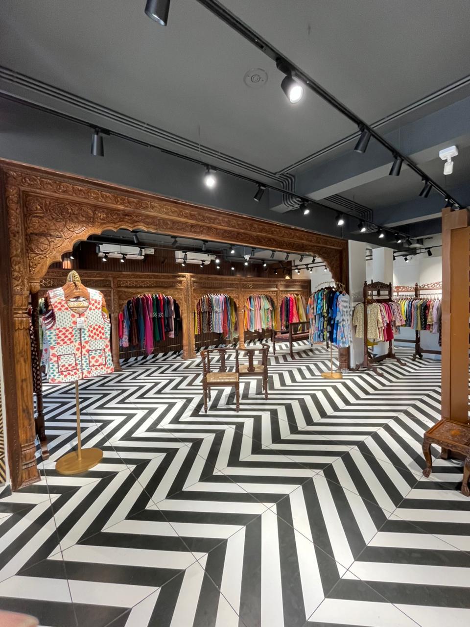Carved wooden arches and clothing racks at the Hawa Sadak store